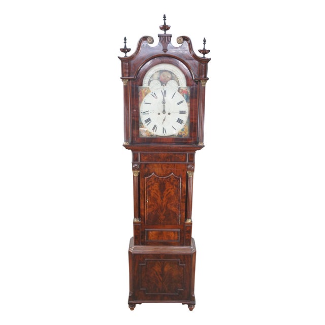 An exceptional early 19th century English George III grandfather clock. Features a beautiful flame mahogany case featuring...