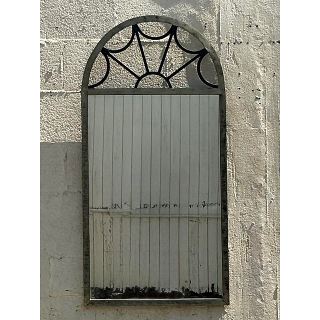 Infuse your space with a touch of dramatic elegance with this striking vintage Regency-style arched mirror. The compelling...