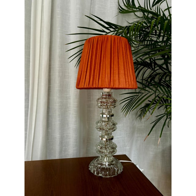 A beautiful crystal glass night lamp, designed by Carl Fagerlund, Orrefors, Sweden, 1960s. The lampshade is a vibrant...