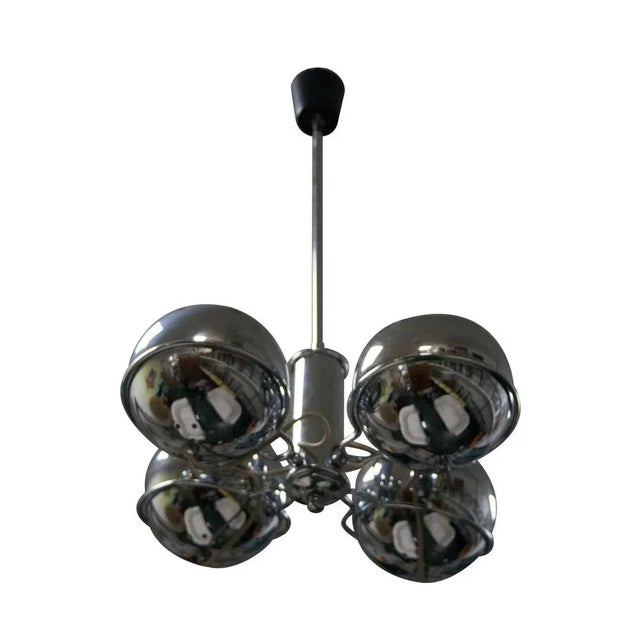 Chromed steel ceiling lamp composed by four spheres laying on a structure which allows light redirectioning. Four light...