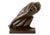This bronze sculpture illustrates a figure leaning forward in a determined walking stance. The character clutches a sack...