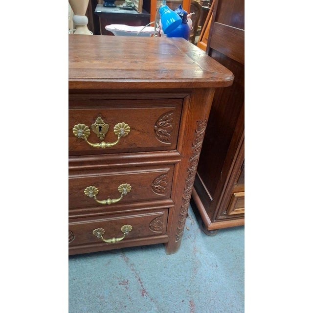 Chestnut and carved oak commode. It opens with four drawers in three rows. The ornaments are bronze. 18th century. Style:...