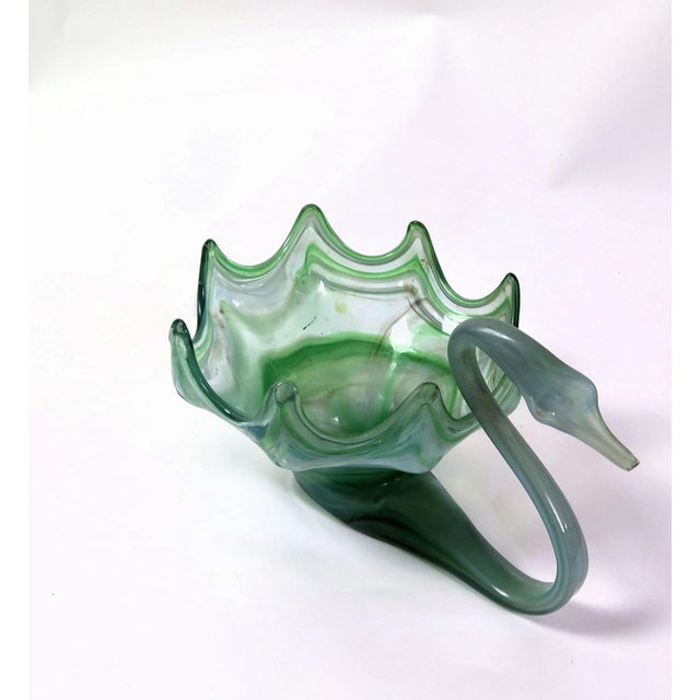 Gradated colors of seafoam green, avocado. and clear Murano glass bowl. The elegant neck, wings, and all other elements of...