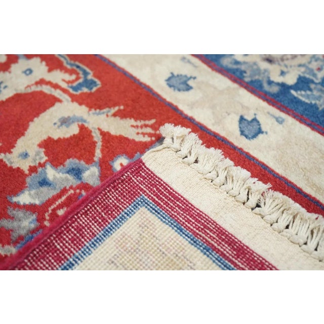 The very crisp cardinal red field shows coiling arabesques, palmettes, perky birds, triple rosettes, lancet leaves and...