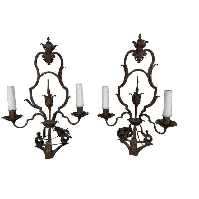 A striking pair of hand-forged wrought iron lamps in the Spanish Revival taste, dating to the early 20th century. Each...
