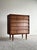 This vintage mid century five-drawer chest features a striking architectural facade defined by deeply recessed drawer...