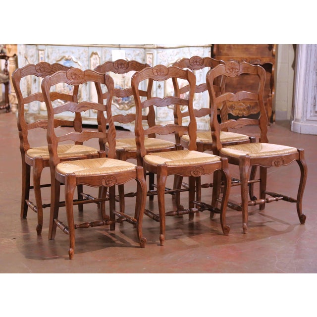 Bring authentic country charm to your dining room with this elegant set of six French Provincial chairs crafted in...