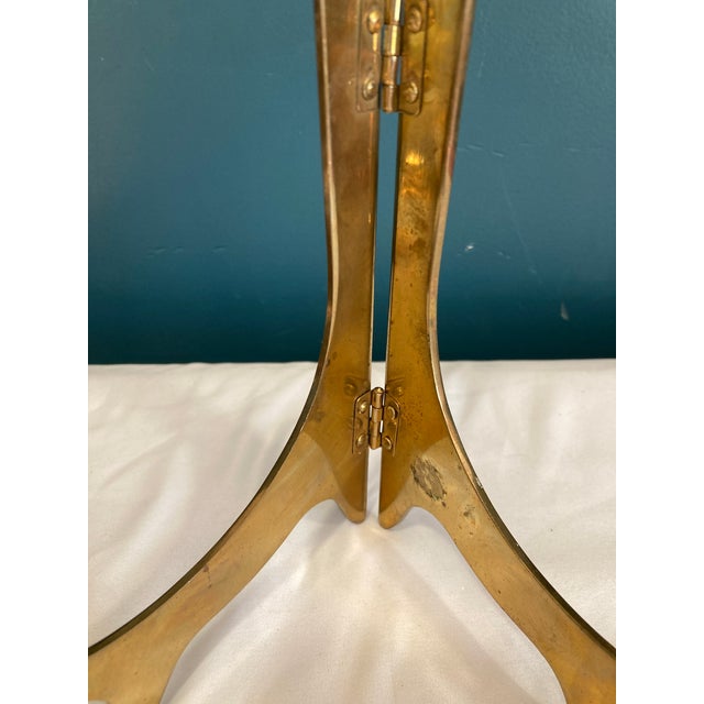 This elegant vintage brass folding display stand offers a classic way to present your favorite vintage finds, artwork,...