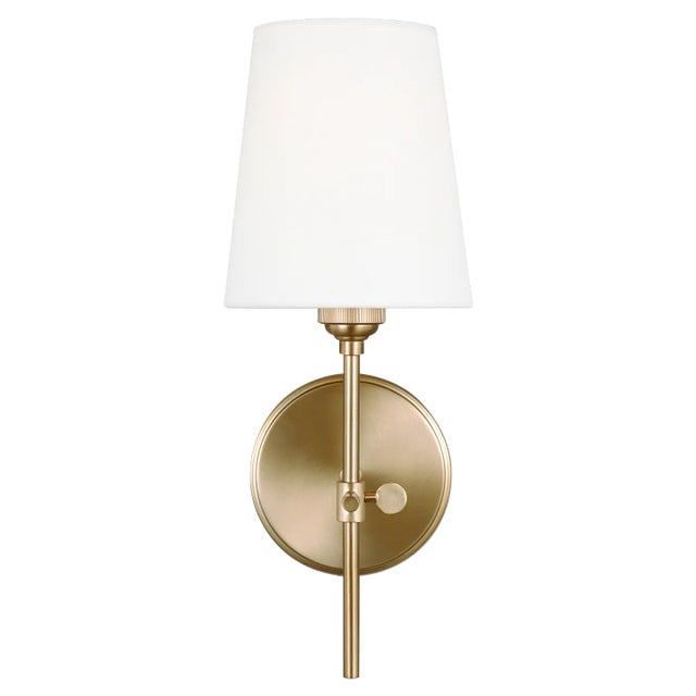 The Baker one light wall sconce in satin brass provides abundant light for your bath vanity, while adding a layer of...