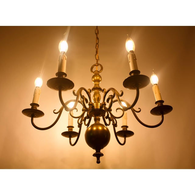 An elegant, smaller six-arm dutch-style chandelier made of bronze, suitable for both classic and period interiors. The...