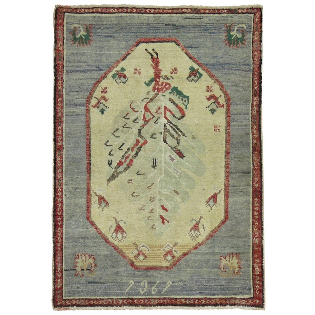 Vintage Turkish Anatolian rug with a trapezoid shaped medallion on a grayish blue field, accents in beige, rust red and...