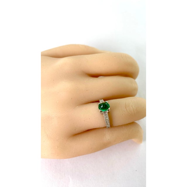 Introducing our exquisite Vintage 14 Karat White Gold Oval Cabochon Colombian Emerald Engagement Ring, a masterpiece of...