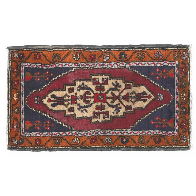 This handwoven Turkish rug features a commanding central medallion in beige, brown, and deep red tones, set against a rich...