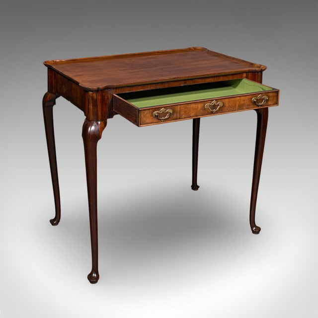 This is an antique silver presentation table. An English, mahogany console or hall table, dating to the Georgian period,...