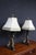 Exceptional pair of French Empire-style bronze table lamps featuring elaborate figural bases with three sculpted dolphins...