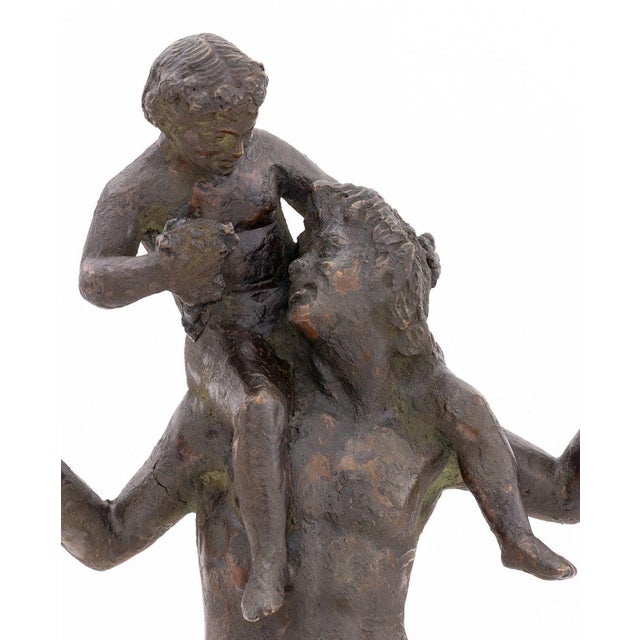 After the Antique Satyr and Young Dionysus Patinated Metal Sculpture, 19th century, the satyr playing cymbals with child...