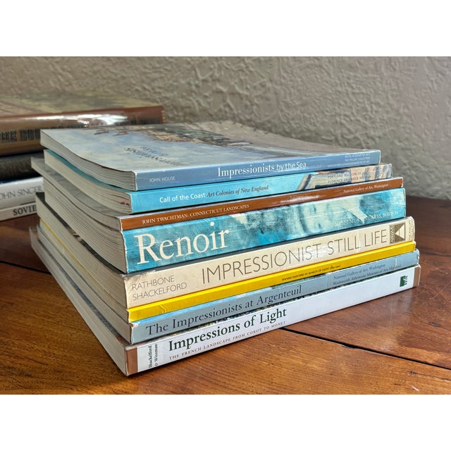 Collection of 8 vintage Impressionist museum exhibition books in coastal colors of grays, blues, yellows and browns. All...