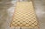 A vintage Turkish Anatolian throw rug. The ivory field displays a brown cartouche lattice which starts a bit uncertainly...