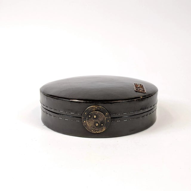 An unusual jewelry yin-yang jewelry box made of wood and bound with leather