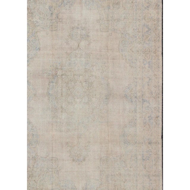 Muted Vintage Turkish Rug in Cream, Gray, Camel and Light Brown Colors. Classical designs and muted colors are hallmarks...