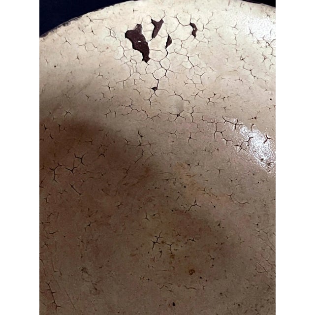 A ceramic tea bowl with milky white glaze made in Korea for Japanese market circa 16-17th century. The thinly potted bowl...