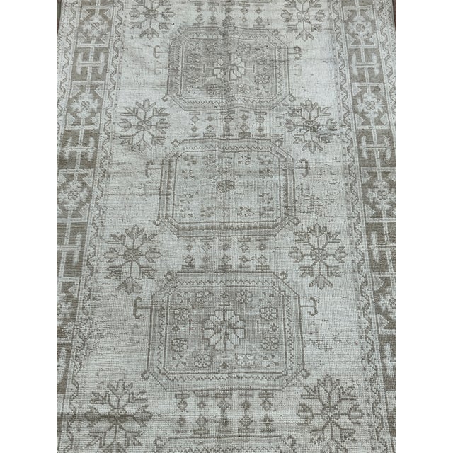Vintage Turkish runner, hand-knotted in Turkey from 100% wool. Measuring 4’5” x 11’, the rug features a traditional...