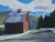 Snowy Road To The Barn by Samantha Buller | Oil on panel depicting a snowy road and barn. For Sale