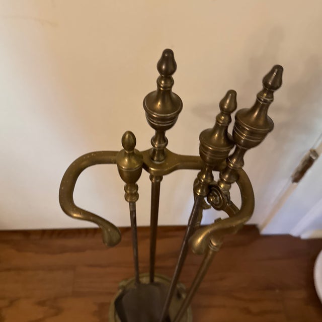 Antique English Georgian or American Federal style brass fireplace or hearth tool set with urn finials. A stand with round...