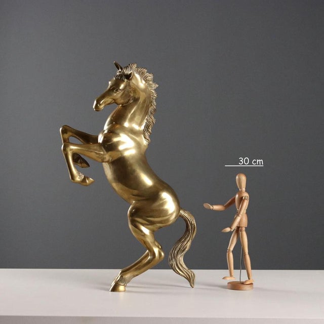 Gilded bronze sculpture depicting a prancing horse. This piece is attributed to the mentioned designer/maker. It has no...
