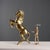 Gilded bronze sculpture depicting a prancing horse. This piece is attributed to the mentioned designer/maker. It has no...