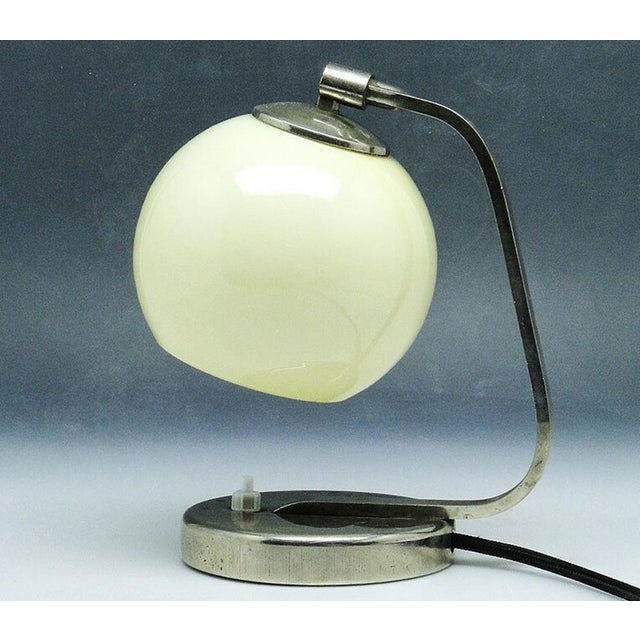 Night light from the 50s. It has a glass shade and metal mount and a base. It is preserved in very good condition. The...