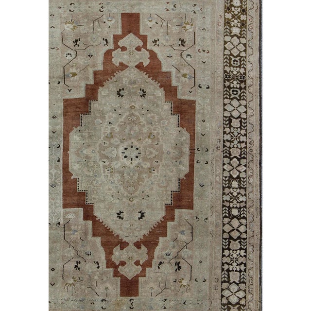 Vintage Turkish Oushak Rug with Geometric Central Medallion in Earth Tones Measures: 7' x 11'5 Country of Origin: Turkey;...