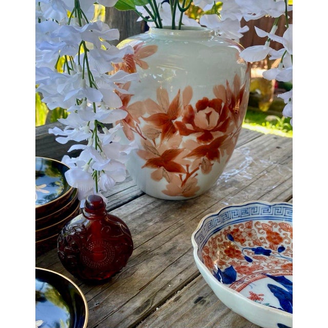 A beautifully executed vintage Japanese porcelain vase featuring a graceful rounded form decorated with hand-painted...