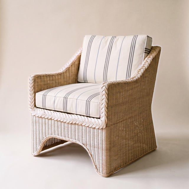 The Westport Wicker Lounge Chair is handwoven from natural rattan. Its barrel back curves forward into the arms and is...