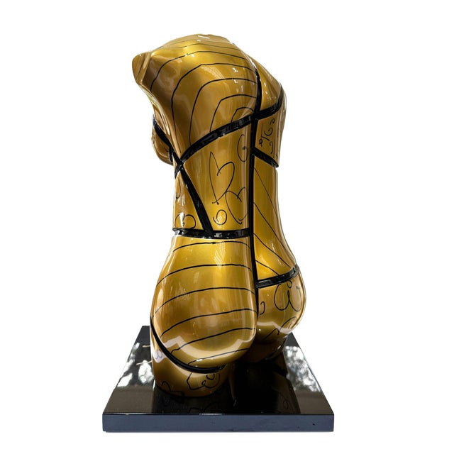 Unique, one of a kind resin sculpture hand embellished with black marker. Hand signed by Romero Britto on the left leg...