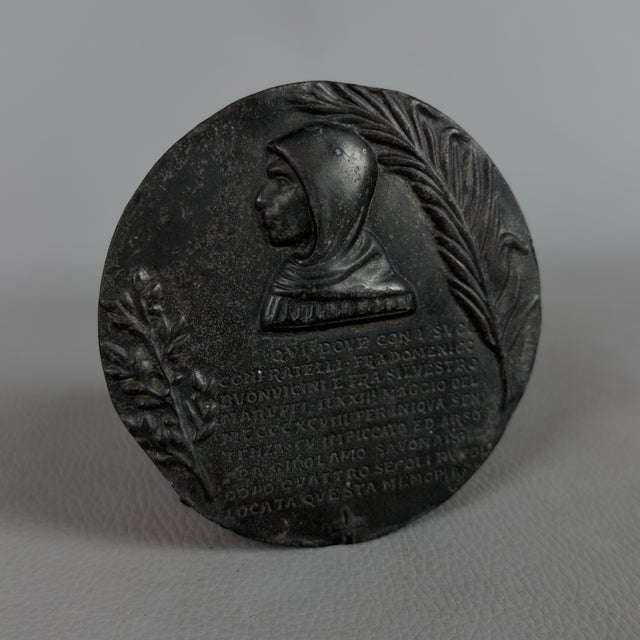 A striking historical wall medallion cast in bas-relief, depicting Girolamo Savonarola and attributed to an early 20th-...