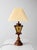 Vintage Mediterranean Revival table lamp featuring faceted amber textured glass, turned wood detailing, and dark metal...