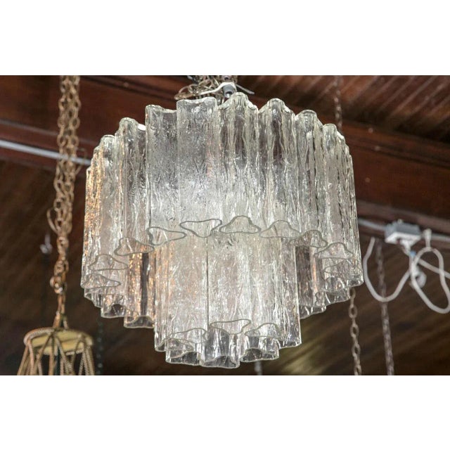 Tronchi glass pieces are triangular. Nine candelabra sockets.