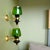 This pair of wall sconces was made in Portugal in the 1990s. The sconces are in metal, with green glass lampshades. The...