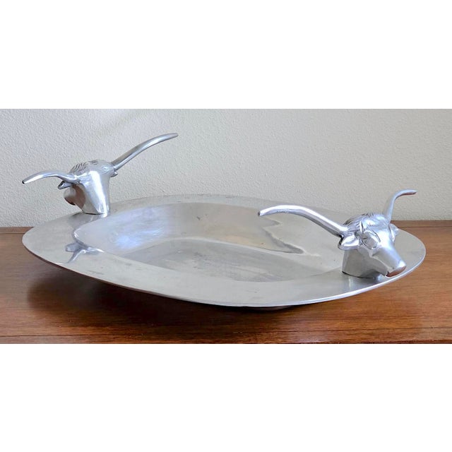 Add a bold touch of vintage Western style to your space with this striking Mid-Century Modern cast aluminum serving tray...