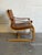 This lounge chair features a cantilevered wood frame with curved armrests and a plush seat cushion. Its organic silhouette...