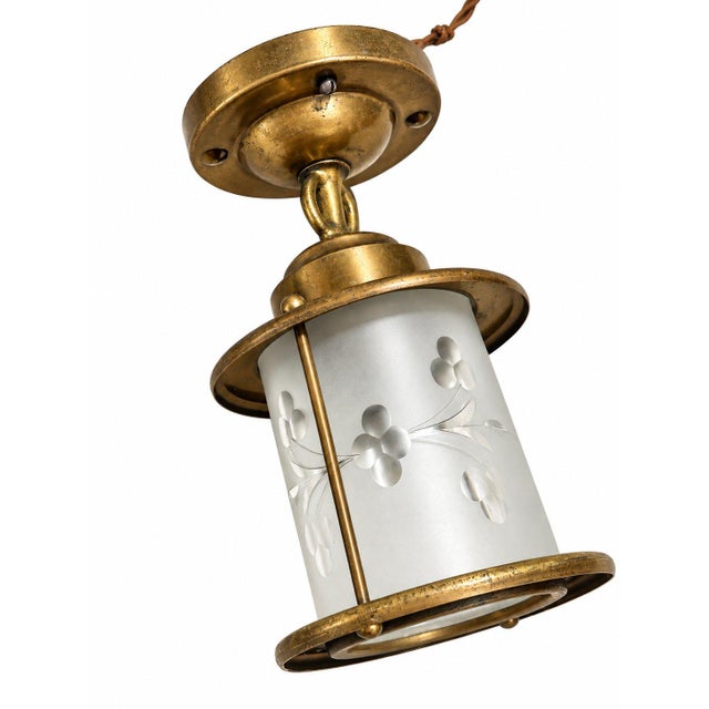 This vintage brass flush-mount ceiling light has a timeless Colonial-inspired design. Delicate floral details on the...