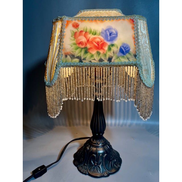 A charming and delicate lamp from the Meyda Lighting, known for its high quality, Tiffany style lamps. Designed by Glynda...