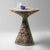 Sade table MOTTLED A sculptural side table with an organic, balanced silhouette and a richly mottled surface. Its broad,...