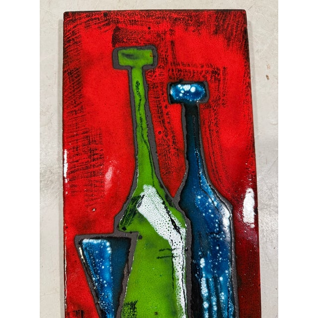Nice colorfull ceramic wall decoration, Germany. Ceramic with a painting of stylized bottles in deep colours and a glossy...