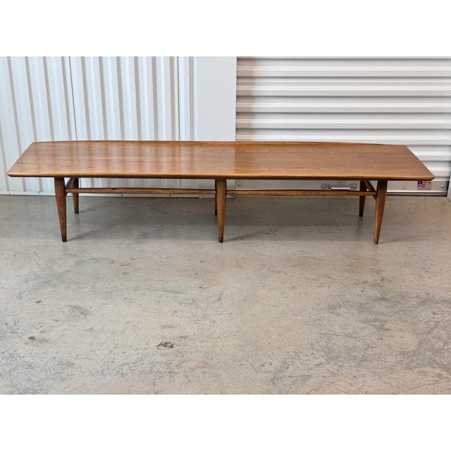 Elevate your living space with this iconic vintage Mid-Century Modern "Surfboard" coffee table from the highly collectible...