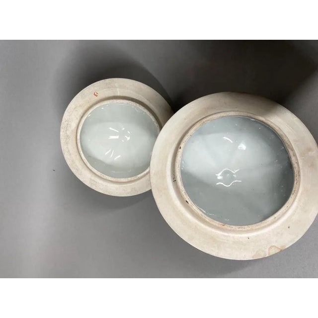 A pair of two antique Chinese Family Verte porcelain vases. Beautifully decorated with handpainted flowery decorations in...