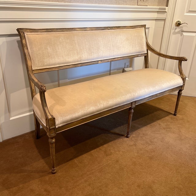 Elegant and timeless Niermann weeks Annecy bench. Wood frame with carved lion handles. Distressed camel and silver leaf...