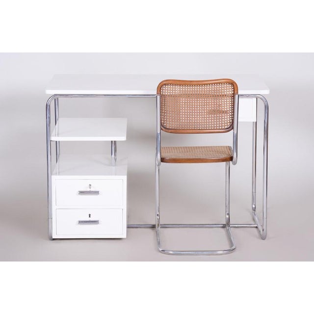 This visually clean and shape-inventive writing desk in the spirit of Bauhaus functionalism dates from the 1930s in...