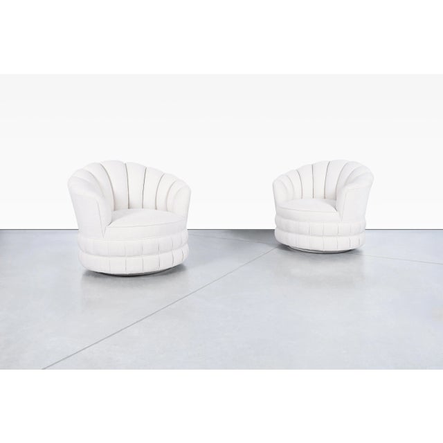 A striking blend of sculptural form and inviting comfort, this pair of mid-century modern swivel lounge chairs captures...